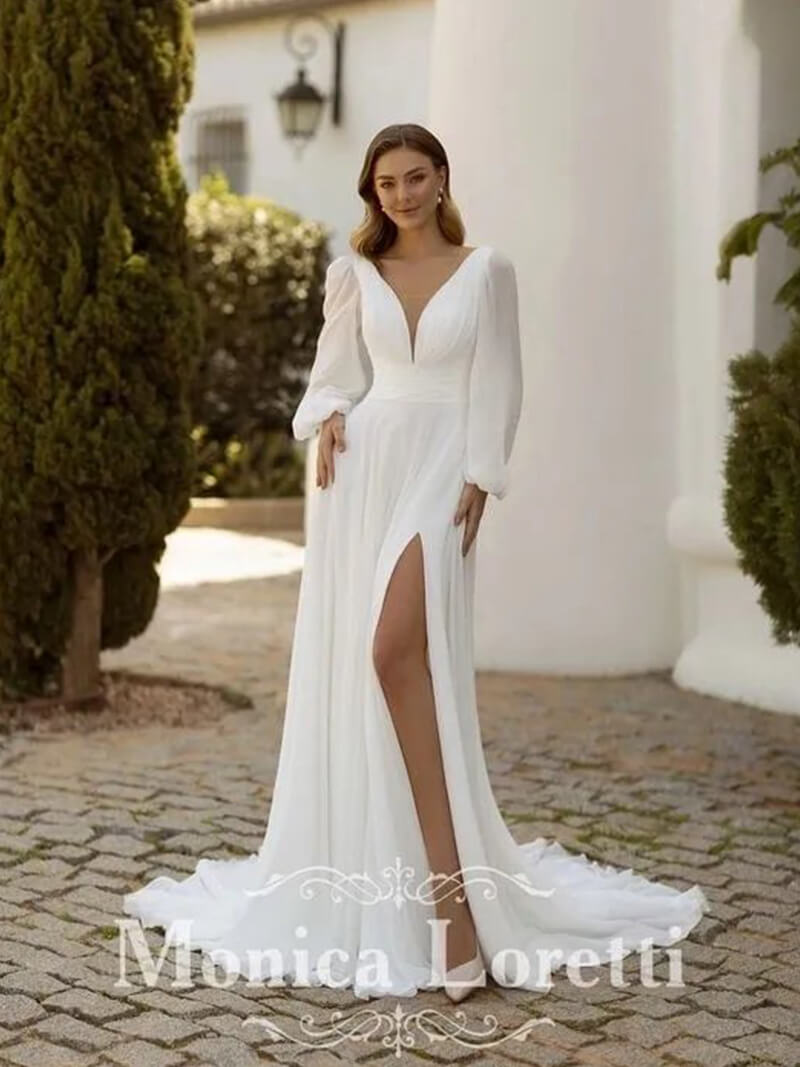 Bride in elegant white wedding dress outdoors.