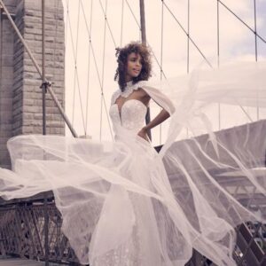 Bride in a white dress on a bridge.