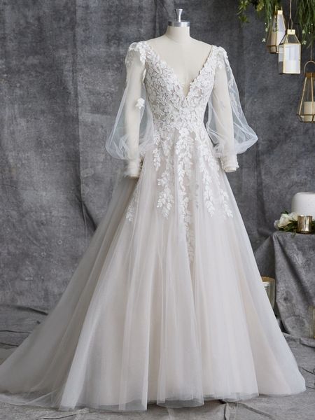 White lace wedding dress with long sleeves.