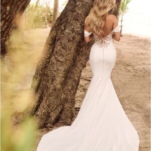 Woman in off-the-shoulder wedding gown.